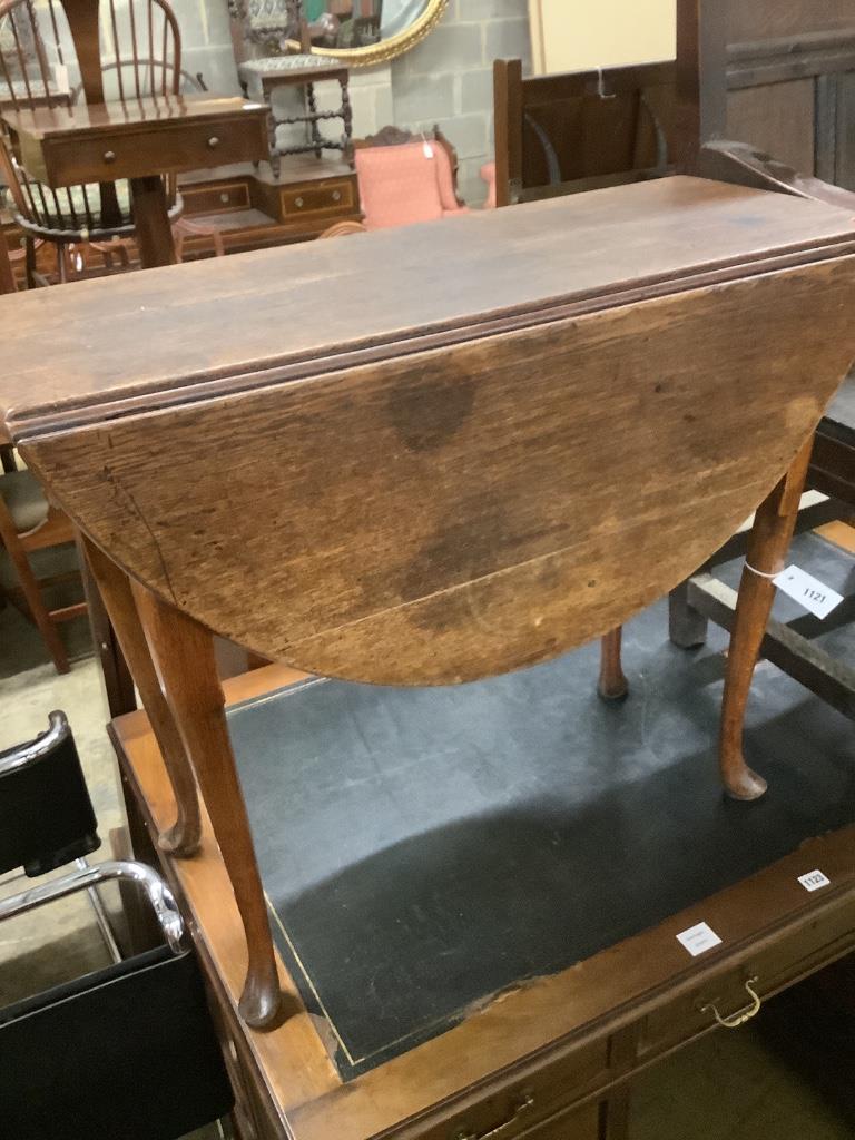 An early 18th century oak oval topped gateleg dining table